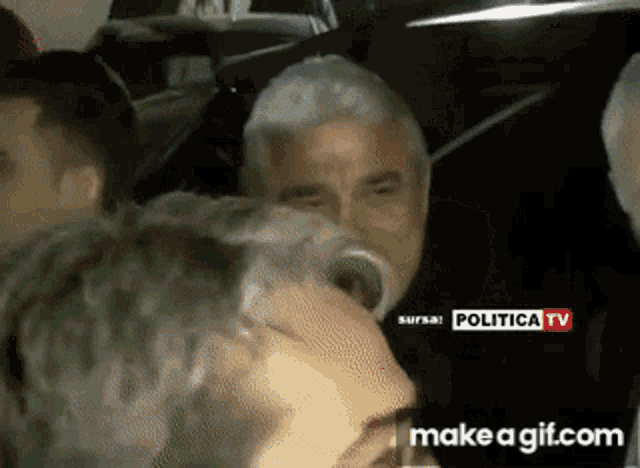 a man drinking from a bottle with a make a gif.com watermark