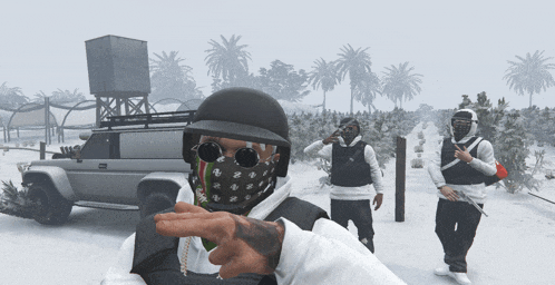 a man wearing a helmet and sunglasses is pointing to the camera