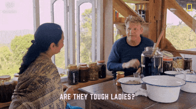 a man sitting at a table talking to a woman with the words are they tough ladies below him