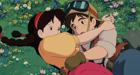 a boy and a girl are hugging each other in a field