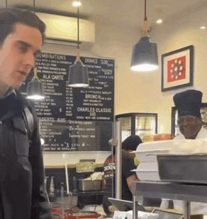 a man is standing in front of a menu that says combinations