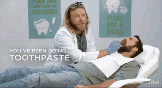 a man is laying in a dental chair while a dentist examines him