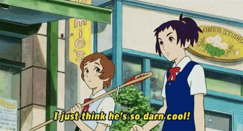 a couple of girls standing in front of a flower studio holding a stick .