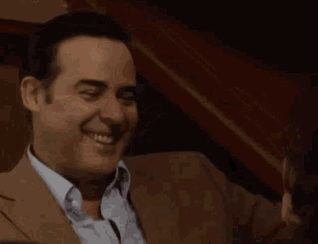 a man and a woman are laughing together in a room .