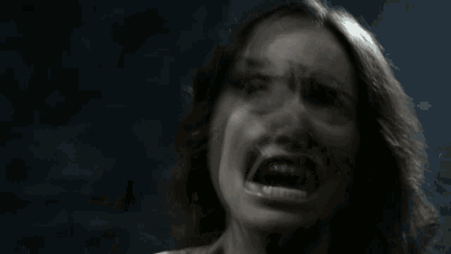 a close up of a woman with her mouth wide open