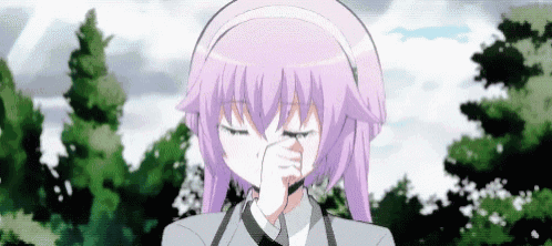 a girl with purple hair and headphones is covering her nose with her hand .