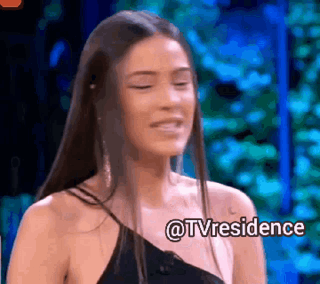 a woman in a black dress is smiling with the words @tvresidence written below her