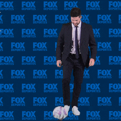 a man in a suit is juggling a soccer ball in front of a fox deportes background