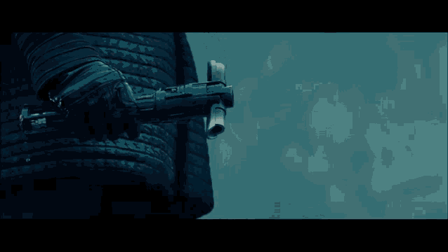 a close up of a person holding another person 's hand in a dark room .