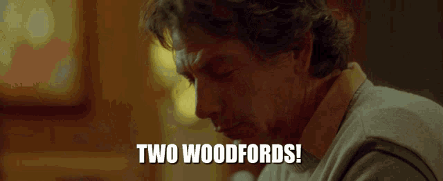a man in a sweater says two woodfords in white letters