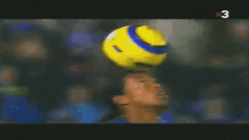 a soccer player kicking a ball with the number 3 on the bottom right