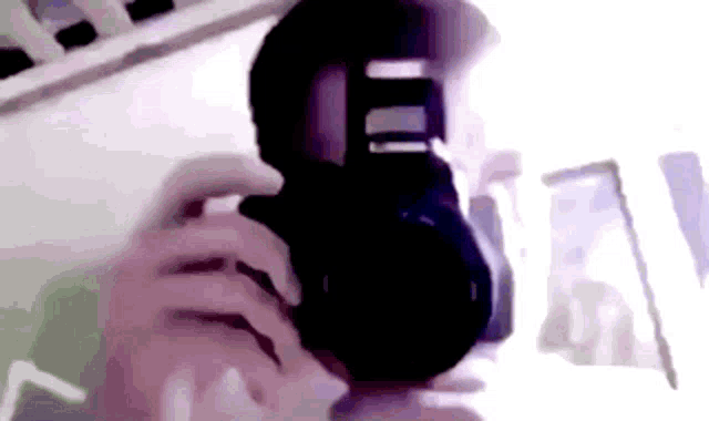 a person is taking a picture with a camera in their hands .