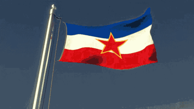 a blue white and red flag with a red star on it