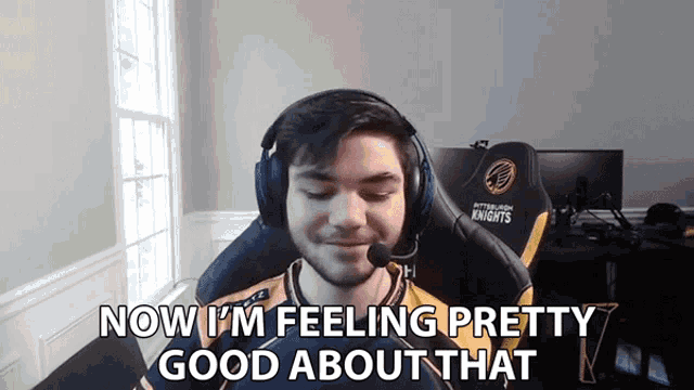 a man wearing headphones is sitting in a gaming chair and says now i 'm feeling pretty good about that