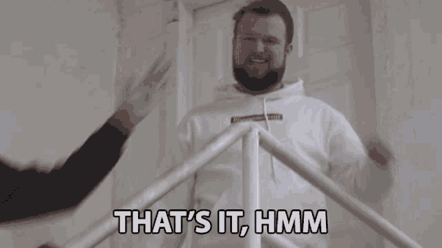 a man with a beard is wearing a white hoodie that says disappointment on it
