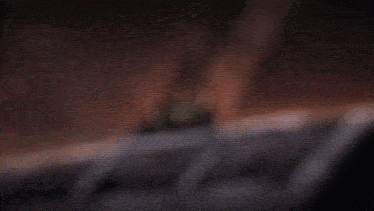 a person 's feet are shown in a blurry picture with a foreign language written below them