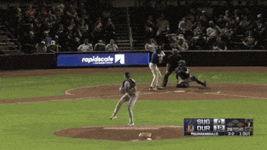 a baseball game is being played with a rapidscale ad in the background