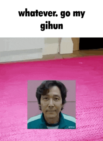 a man is standing in front of a pink rug with the words `` whatever go my gihun '' written on it .