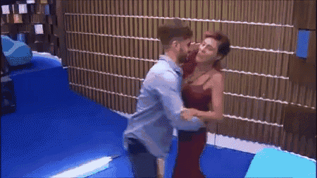 a man and a woman are dancing together in a room