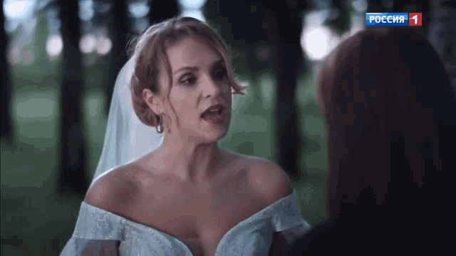 a woman in a wedding dress is talking to another woman on a television screen that says russia