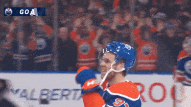a hockey player with the number 9 on his jersey is celebrating a goal