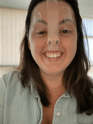 a woman with a piece of tape on her nose smiles for the camera