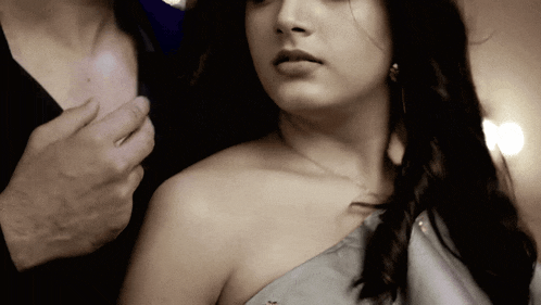 a woman 's shoulder is being held by a man 's hand