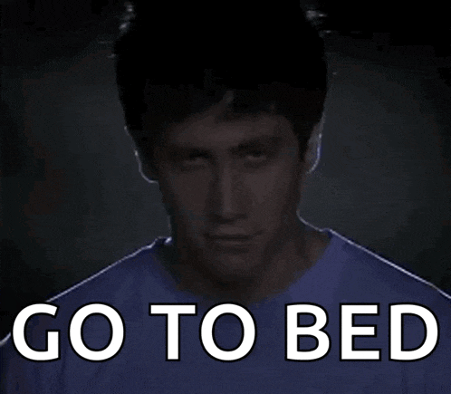 a man in a purple shirt with the words go to bed written on it