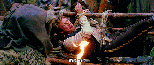 a man laying on the ground with a fire coming out of his chest says wait wait