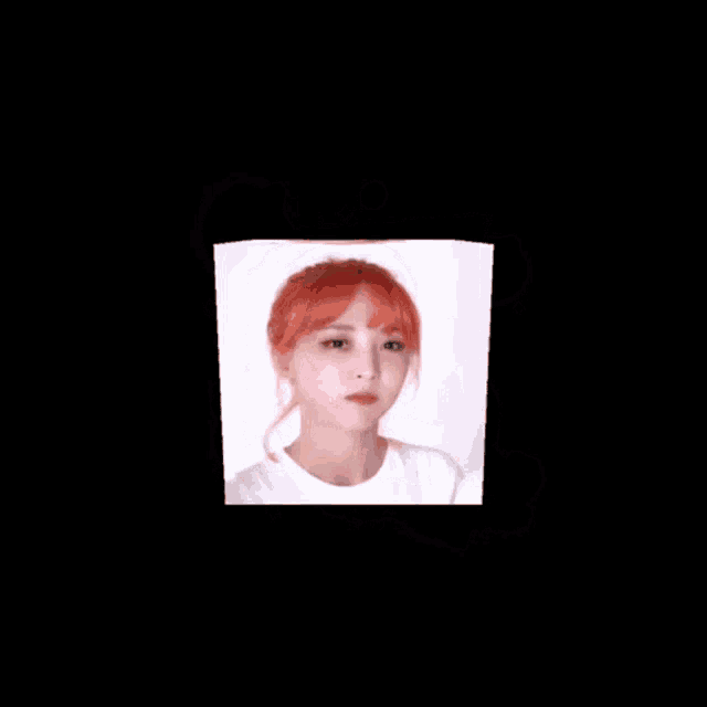 a young woman with red hair is wearing a white shirt and making a funny face .