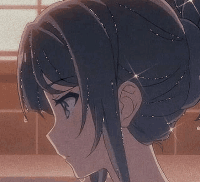 a close up of a girl 's head with a bun and a tear coming out of her eye .