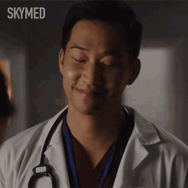 a man in a lab coat with a stethoscope around his neck is smiling with the words skymed above him