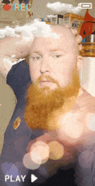 a man with a red beard is being recorded with the play button