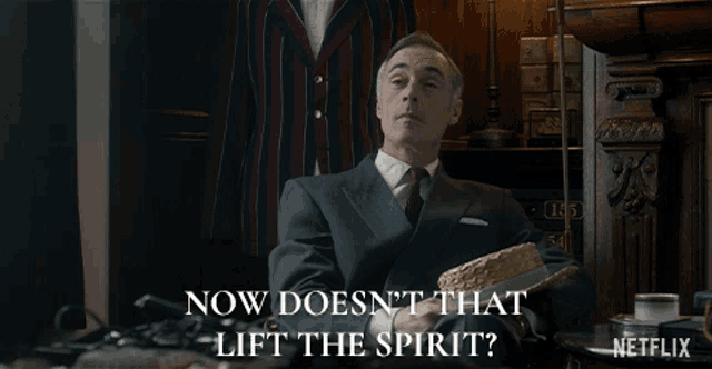 a man in a suit says now doesn 't that lift the spirit
