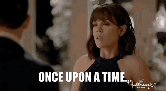 a woman in a black dress is talking to a man and the words once upon a time are above her
