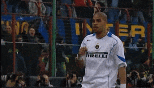 a man wearing a white and blue shirt with the word relli on it