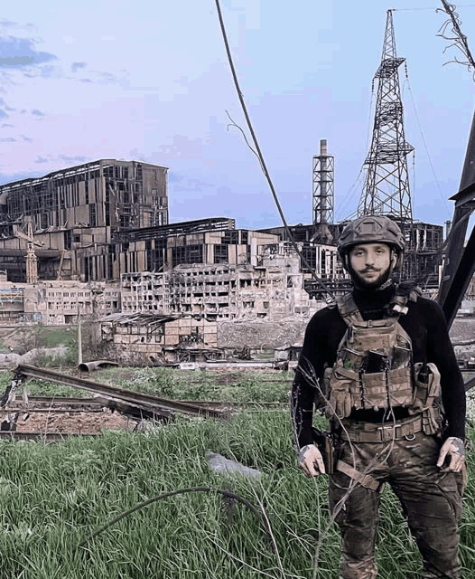 a man in a military uniform stands in front of a destroyed city