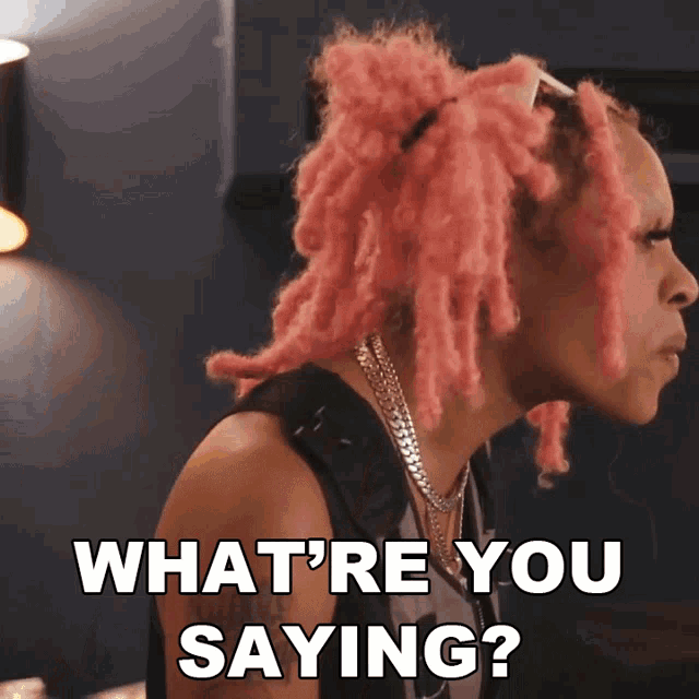 a woman with pink dreadlocks is asking what 're you saying