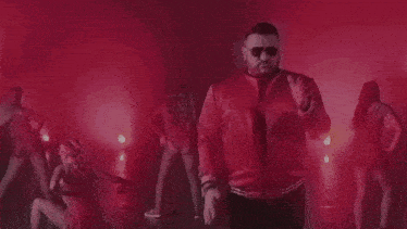 a red background with a blurred image of a person 's face .