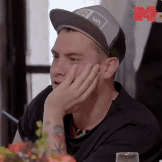 a man wearing a hat that says rvca on it