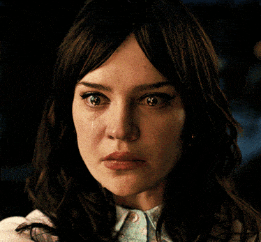 a close up of a woman 's face with her eyes closed