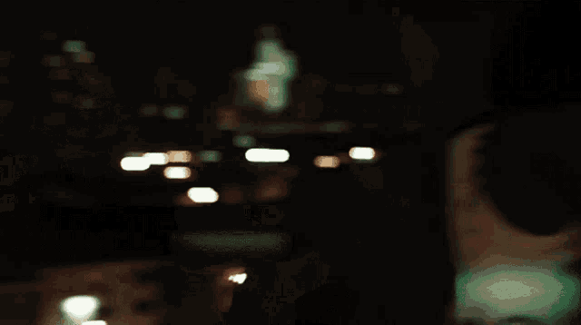 a blurry picture of a man wearing a hat at night