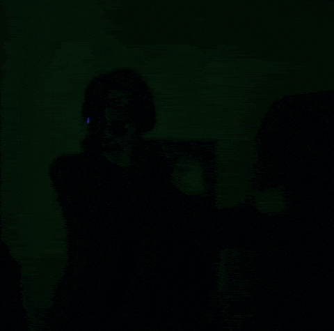 a blurry image of a person in a dark room