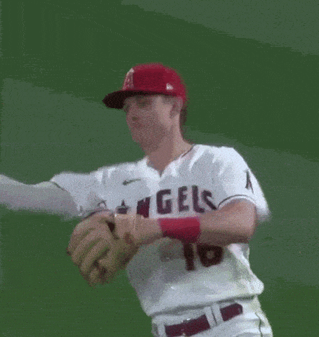 a baseball player wearing a red hat and a white jersey with the number 16 on the back .