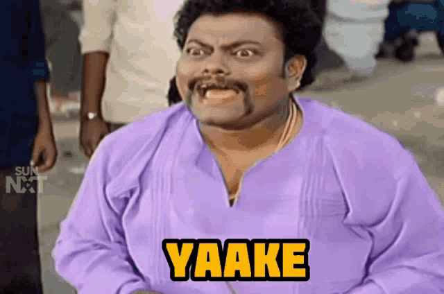 a man in a purple shirt with yaake written on his chest