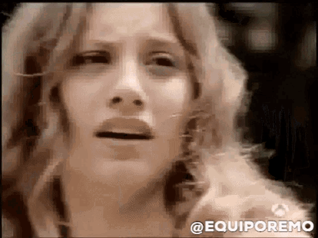 a close up of a woman 's face with the words equiporemo written on the bottom .