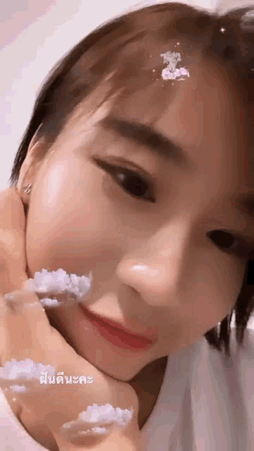 a close up of a woman 's face with a cloud on her forehead