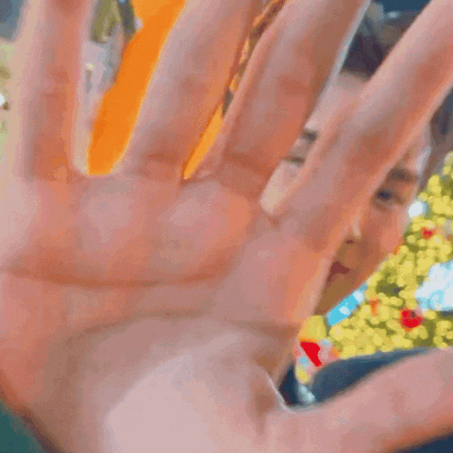 a close up of a man 's hand reaching out towards the camera .