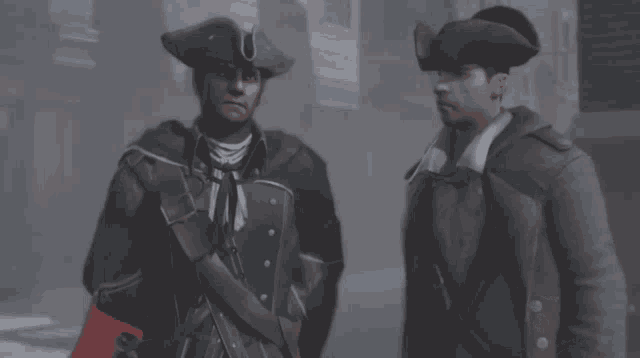 two men in military uniforms are standing next to each other and talking