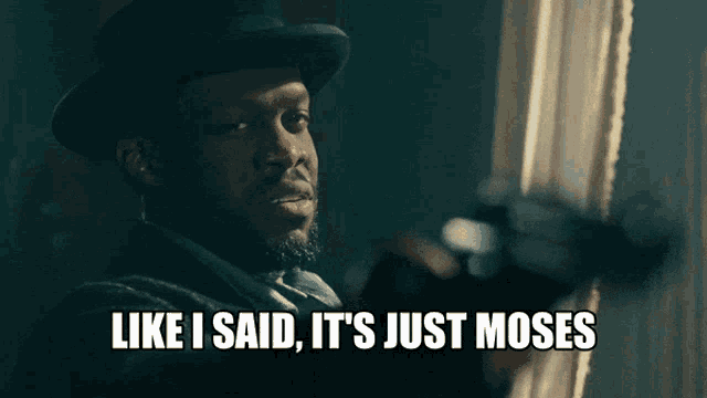 a man in a top hat is holding a gun and says " like i said it 's just moses "